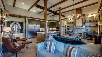 A spacious living area with a sofa, chairs, and a fireplace.