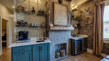 A kitchen with a stone wall, a map, and a whiskey house sign.