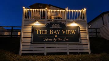 A sign for 'The Bay View' with a tagline 'Home by the Sea'.