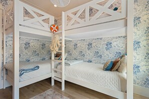A bunk bed room with a nautical-themed wallpaper, a hanging octopus decoration, and a patterned rug. - Luxury on Eastern Lake | Lakefront | Private Pool | 6 Beach Bikes (Santa Rosa Beach)
