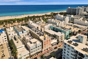 A coastal urban area with a beach, buildings, and palm trees. - Chic 1BR Condo in Prime South Beach Ocean 1 Min Away 306 (Miami Beach)