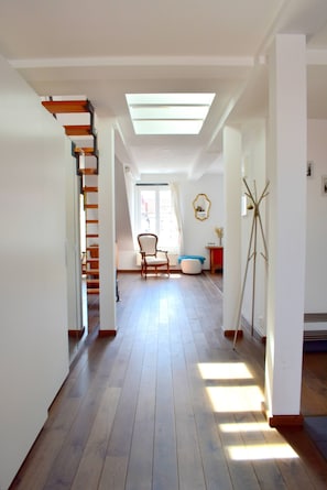 A spacious hallway with wooden flooring, a staircase, and a skylight. - Rooftop Terrace Loft Apartment, Home Cinema (Prague)
