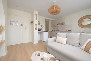 A modern living room with a sofa, a coffee table, and a kitchen in the background. - Free parking • Downtown on foot • Air Conditioning (Albi)