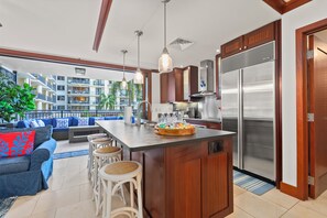Pull up a stool at the breakfast bar and making dinner turns into the evening's plan. - Ko Olina Beach Villas O211 by Gather - 3BR Condo w/ Covered Lanai & Resort Pool (Kapolei)