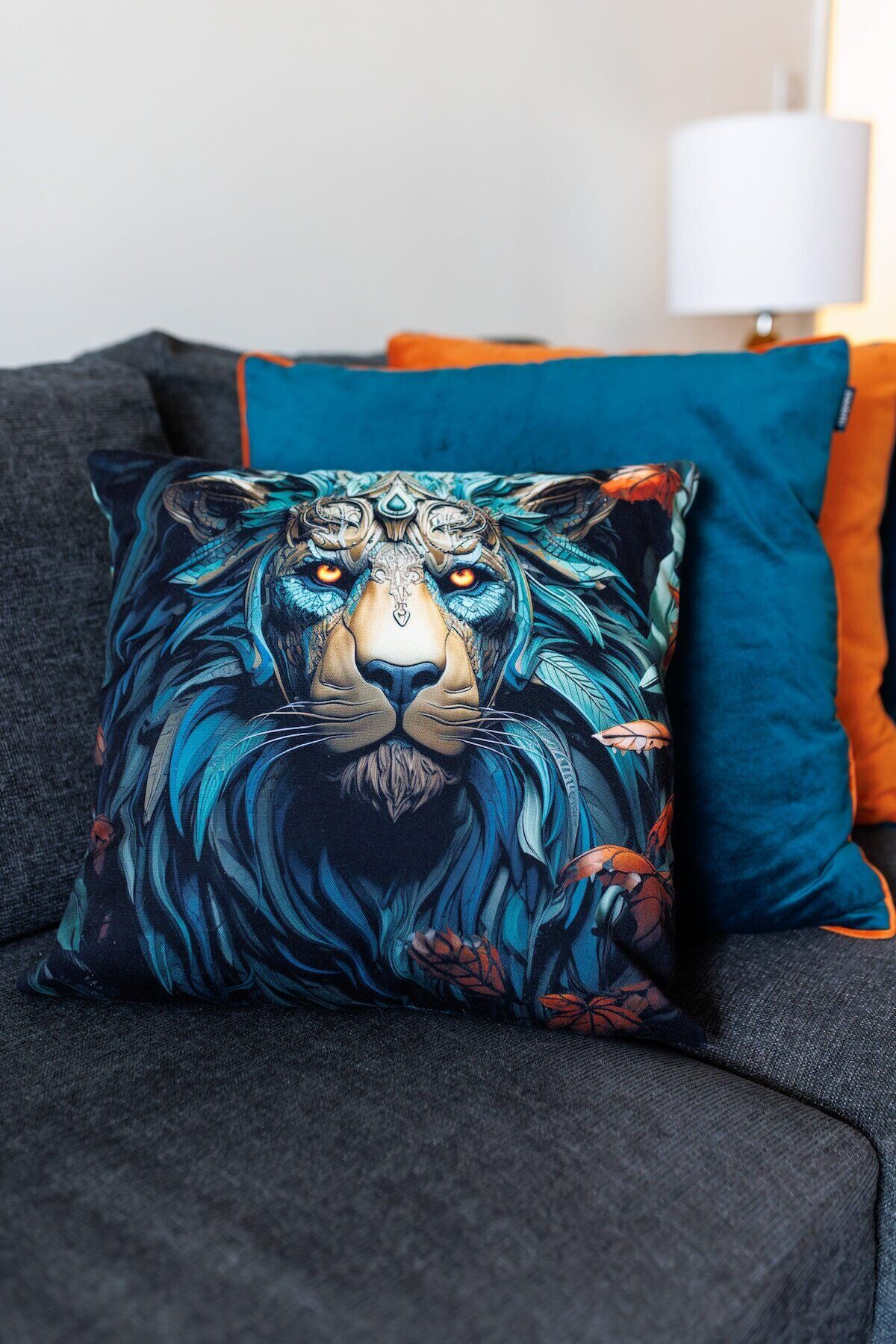A sofa with a decorative pillow featuring a lion's face.