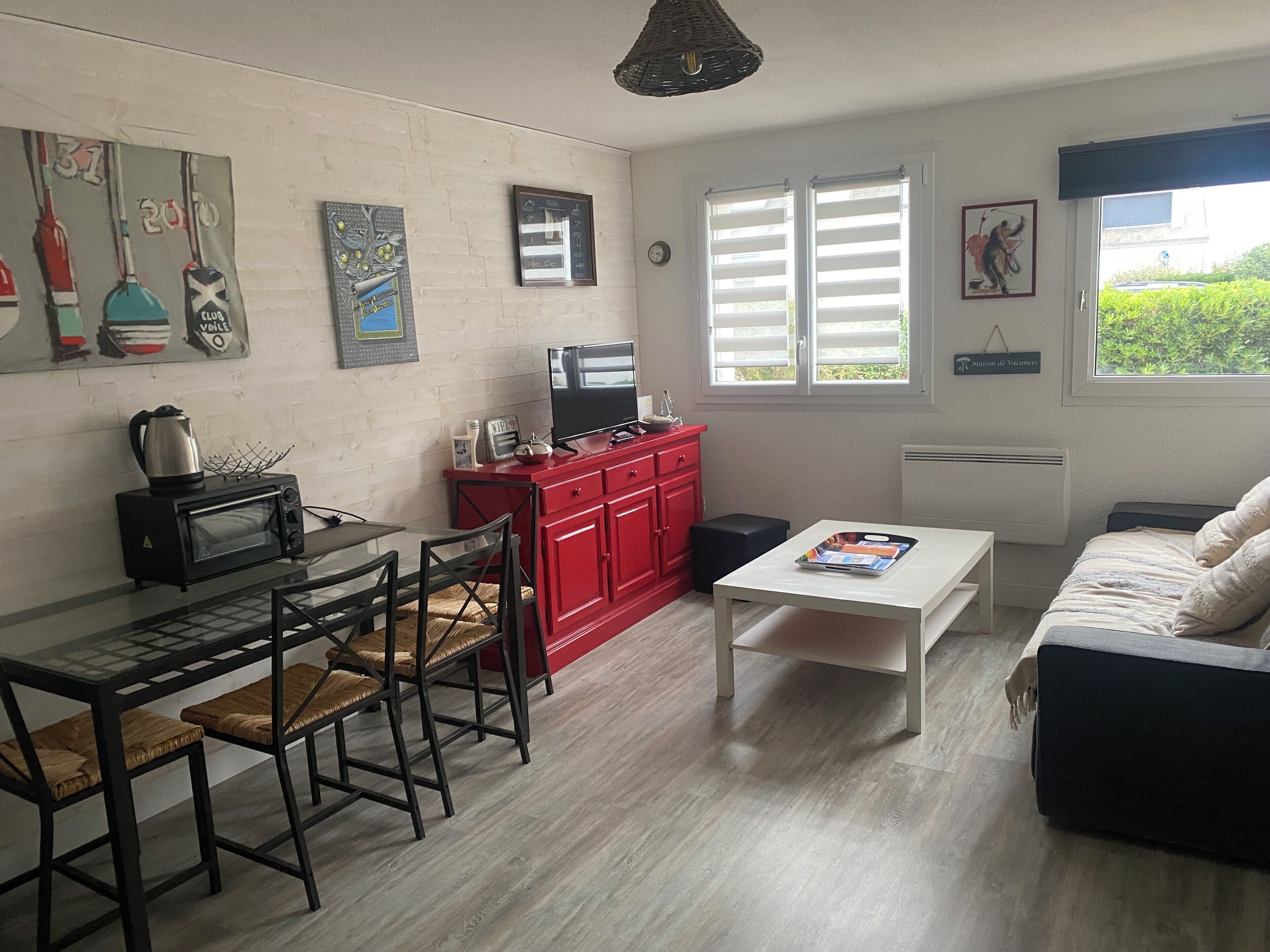 A compact living space with a kitchenette, a dining area, and a seating area.