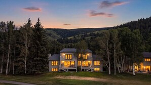 A two-story house with a balcony, surrounded by trees and a hilly landscape. - Golf Course Views W/ EagleVail Amenities (avon)