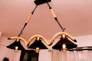 A ceiling-mounted light fixture with three lamps. - Luxury Studio Apartment in Kimana Near Amboseli (Oloitokitok)