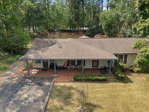 A single-story house with a covered porch, a front yard, and a driveway.