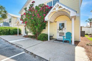 A residential house with a porch, a bicycle, and a chair. - Beachfront Townhome w/ Pool (Destin)