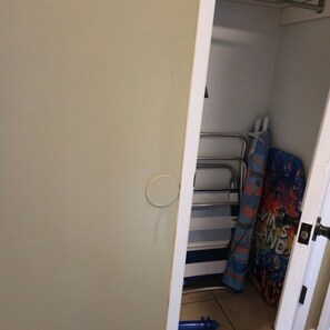 A narrow hallway with a metal rack and folded items, possibly bedding or towels. - Pet-Friendly Townhome w/ Fire Pit, 5mins to Beach (Fort Walton Beach)