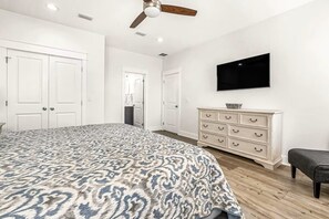 A bedroom with a bed, a dresser, a television, and a ceiling fan. - Clear Sky: Private Pool & Spa | FREE Golf Cart | 2 Family Rooms | Walk to Beach (Destin)