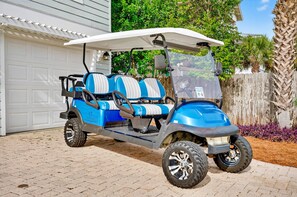 A golf cart parked in front of a house with a garage. - Clear Sky: Private Pool & Spa | FREE Golf Cart | 2 Family Rooms | Walk to Beach (Destin)