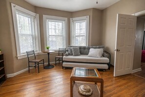 A living room with a sofa, chairs, a coffee table, and a door. - Mount Washington 4BR Home, Sleeps 10, 2 Kitchens (Pittsburgh)