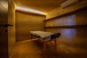 A small, dimly lit room with a wooden bench, a white cloth on it, and a wall-mounted shelf with a few items. - Luxury 4BR Villa in Tulum | Jaguar Park & Beach (Tulum)