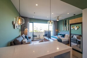 A modern hotel room with a large window, a dining area, and a seating space. - Modern Studio | Gym + Rooftop Pool, Free Parking (Playa del Carmen)