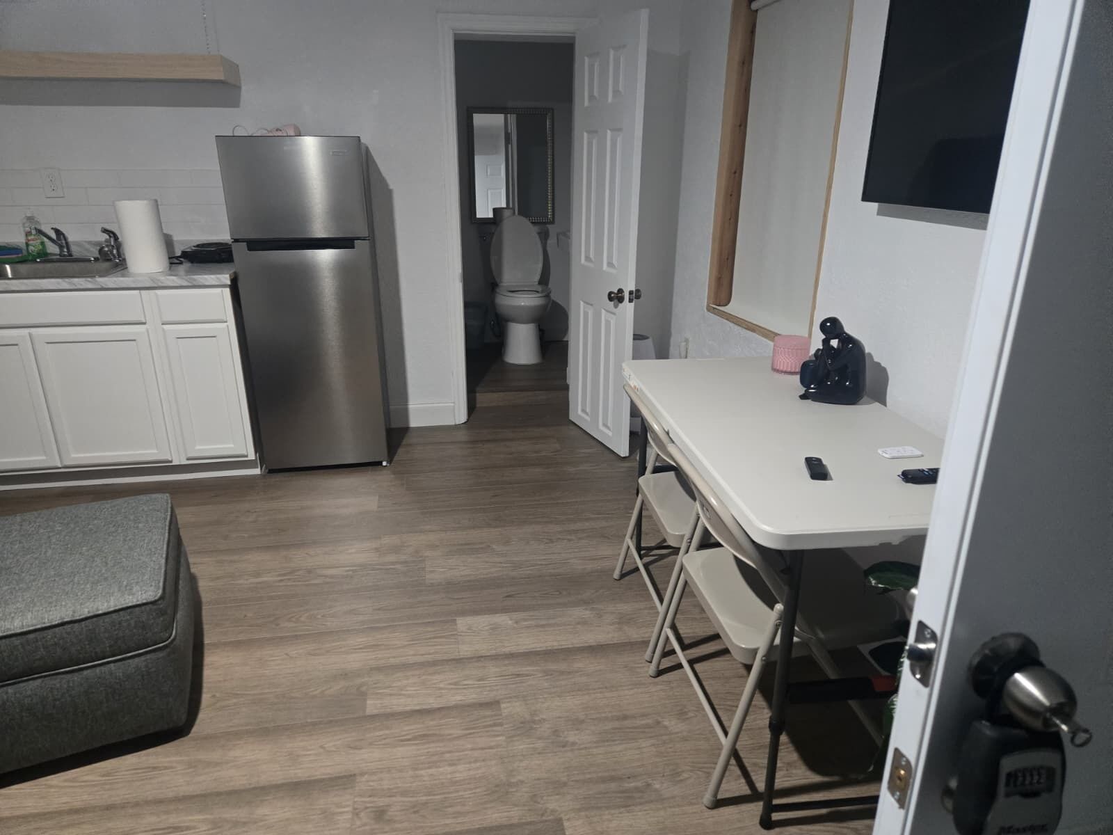 A compact kitchen with a refrigerator, a sink, and a countertop.
