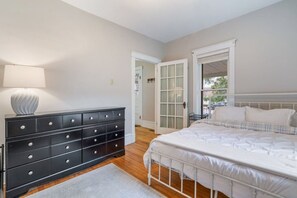 A bedroom with a bed, a dresser, and a lamp. - Charming 2 bedroom home next to Mayo (Eau Claire)