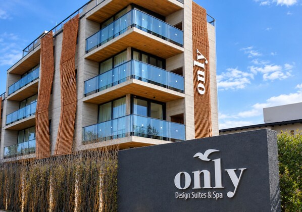 A multi-story building with a sign that reads 'only Design Suites & Spa'.