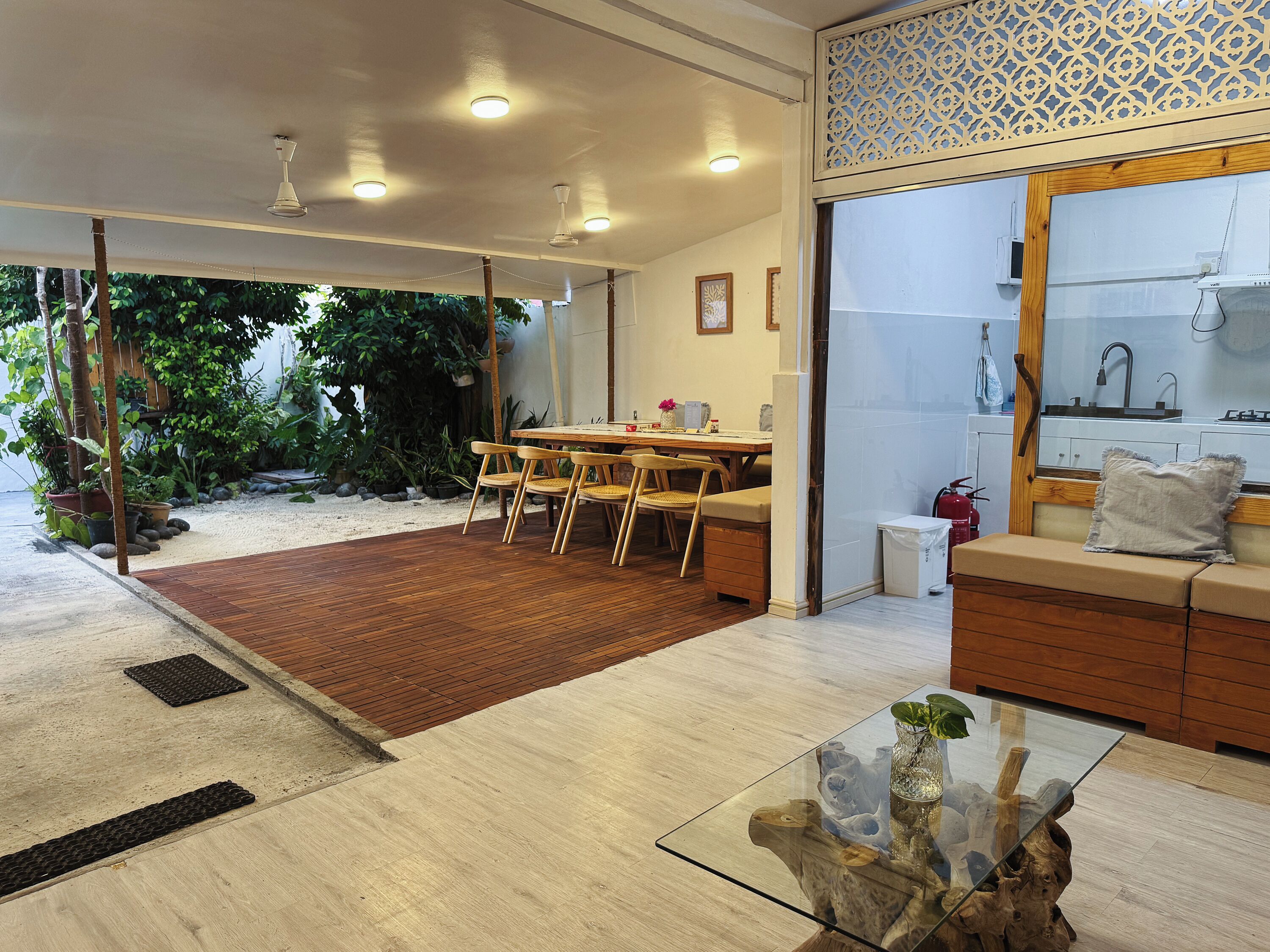 A modern interior with a dining area, a seating area, and a kitchen.