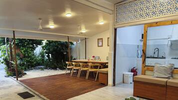 A modern interior with a dining area, a seating area, and a kitchen.