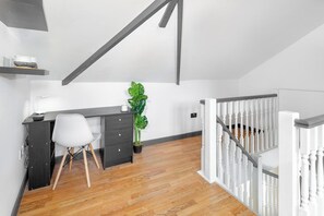 A modern loft bedroom with a desk, chair, and a large plant. - Flatzy - Stunning Victorian Flat in Centre + Xbox (Liverpool)
