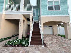 A two-story house with a front entrance, a staircase, and a garage.