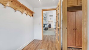 A hallway with wooden flooring, a wooden coat rack, and a wooden wardrobe. - Waterview w Dock and Fishing, Wrap around deck (Mapleton)