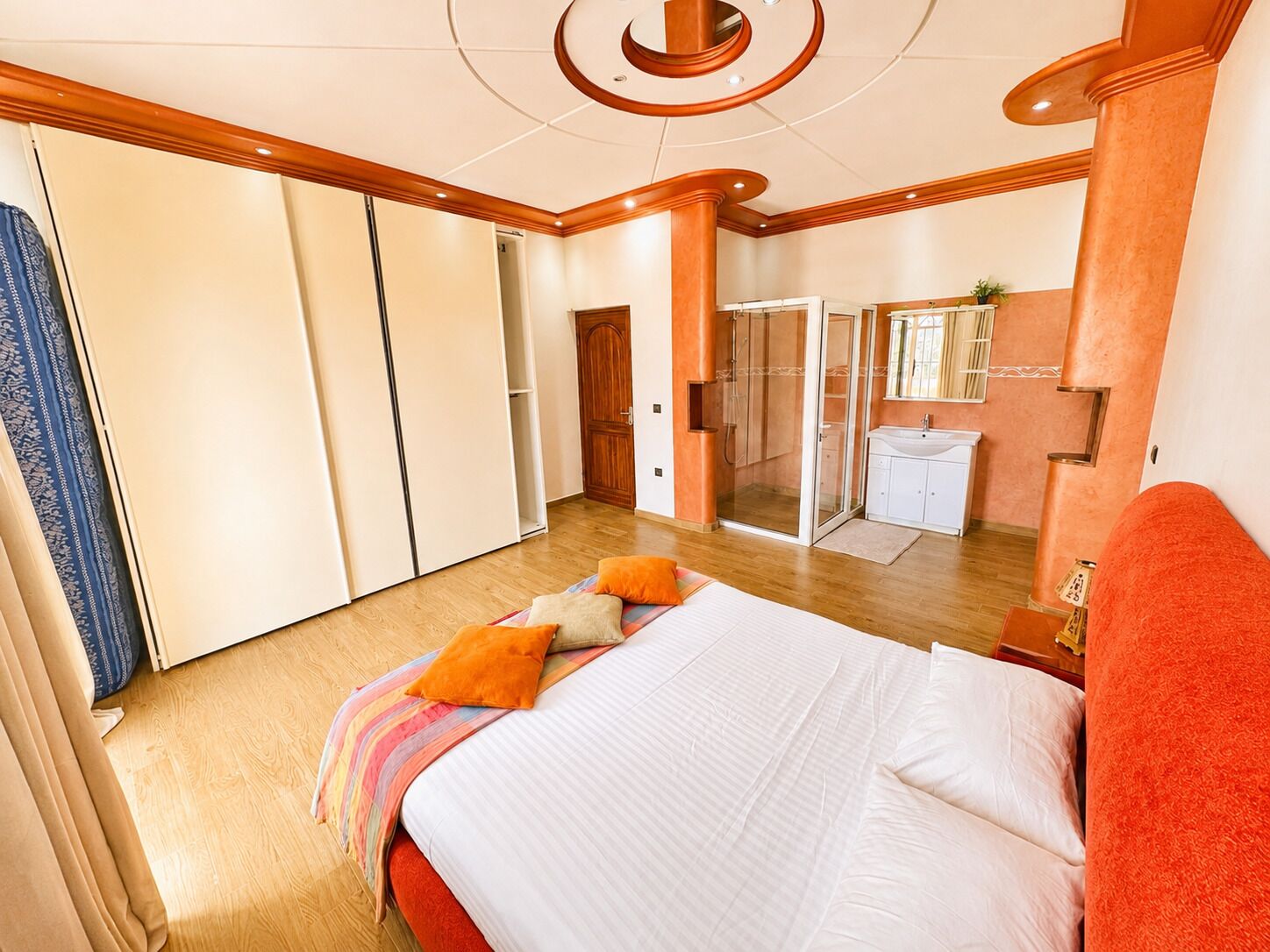 Quarto de hotel com uma cama, chuveiro e banheiro.