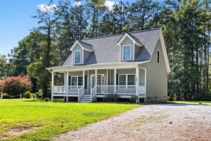 A two-story house with a porch, a front door, and a driveway leading to the entrance. - Walk to Boat Ramp Lake Keowee w/ Parking + Firepit (Seneca)