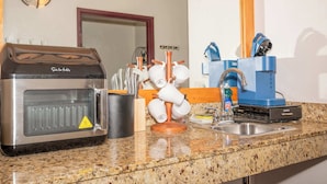 A kitchenette with a coffee maker, a kettle, and a sink. - Chula Condo 2237 & 2239 (Wisconsin Dells)
