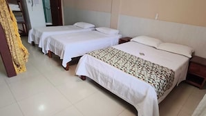 A hotel room with two beds, a painting on the wall, and a refrigerator in the corner. - Pousada Praia Grande (Fundão)