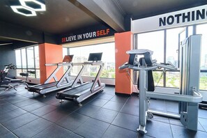 A gym with treadmills, weight machines, and a motivational sign. - 2-bedroom apartment with three beds in charming westlands-Nairobi (Nairobi)