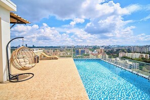 A rooftop pool with a city view, a hanging chair, and a sun lounger. - 2-bedroom apartment with three beds in charming westlands-Nairobi (Nairobi)