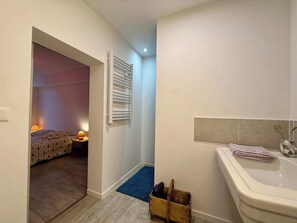 Una camera da letto con un letto, una lampada da comodino e un termosifone.