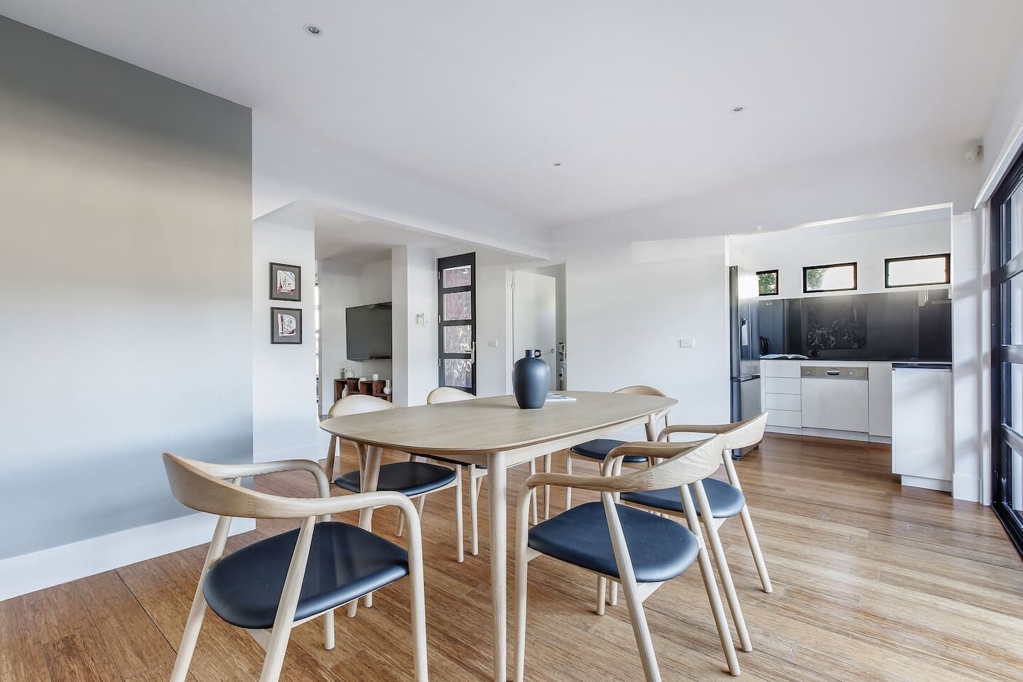 A modern kitchen with a dining area.