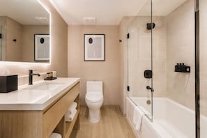 Ein modernes Badezimmer mit Waschbecken, Toilette und einer Duschkabine.