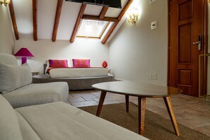 A cozy room with a sofa, a glass-top table, and a bed with colorful pillows. - Second-floor apartment, ideal for large families and groups of friends (Catania)