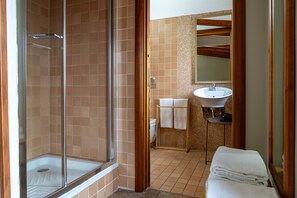 A bathroom with a glass shower enclosure, a sink, and a mirror. - Second-floor apartment, ideal for large families and groups of friends (Catania)
