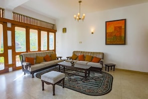 A living room with two sofas, a coffee table, and a patterned rug. - Royal Eco Lodge Kandy (Kandy)