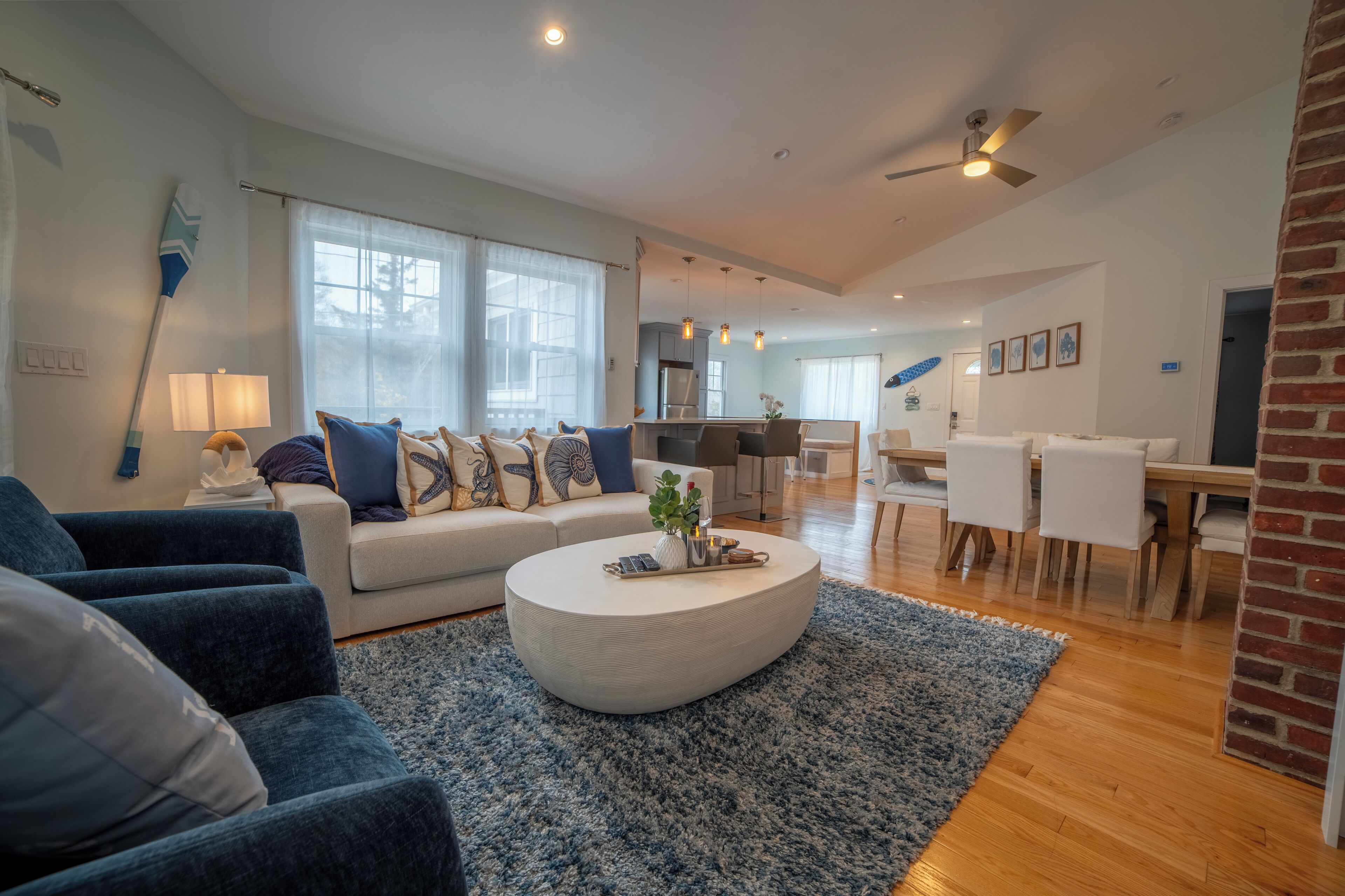 A modern living room with a sofa, coffee table, and dining area.
