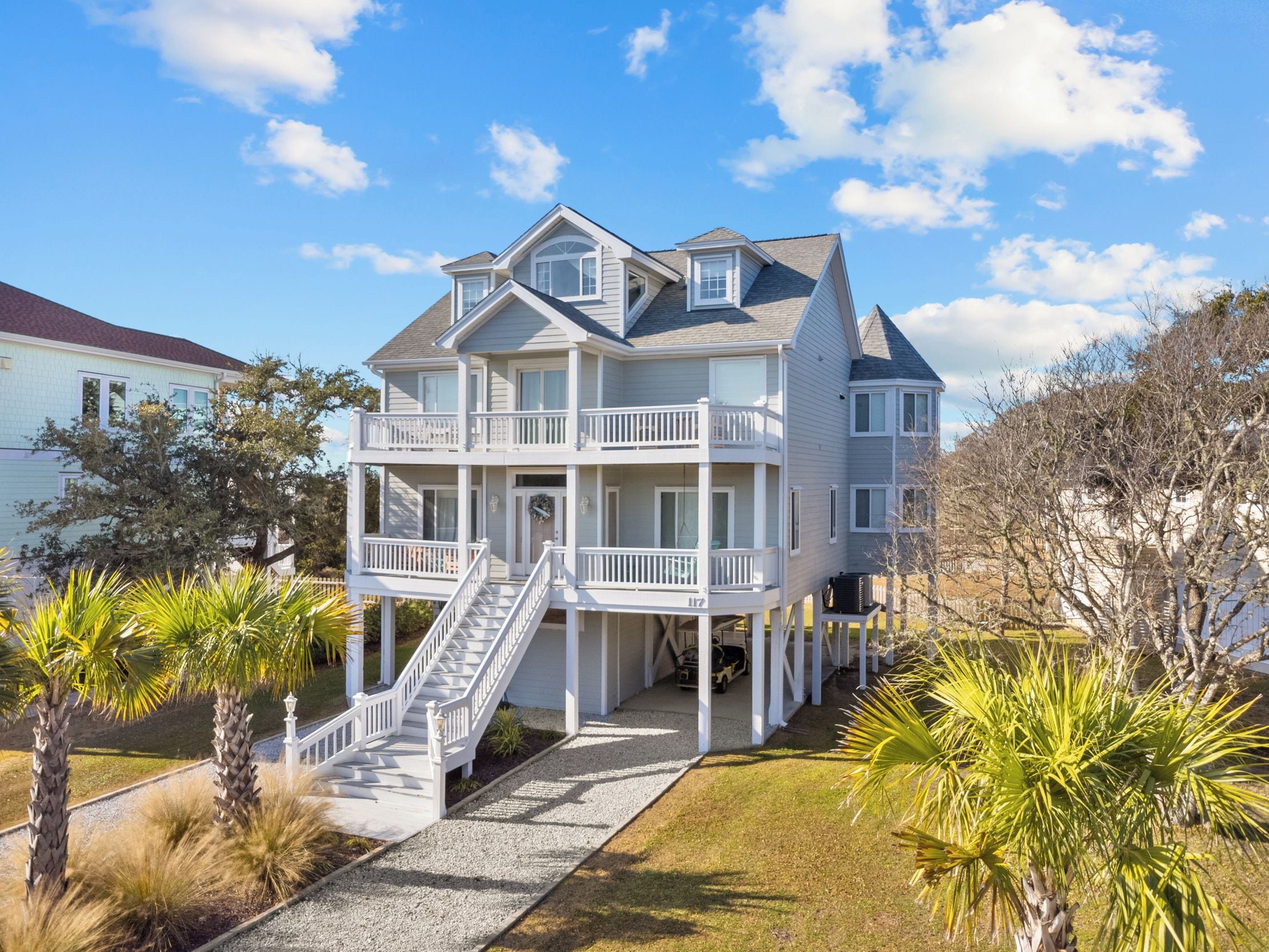 A two-story house with a balcony and a covered porch.