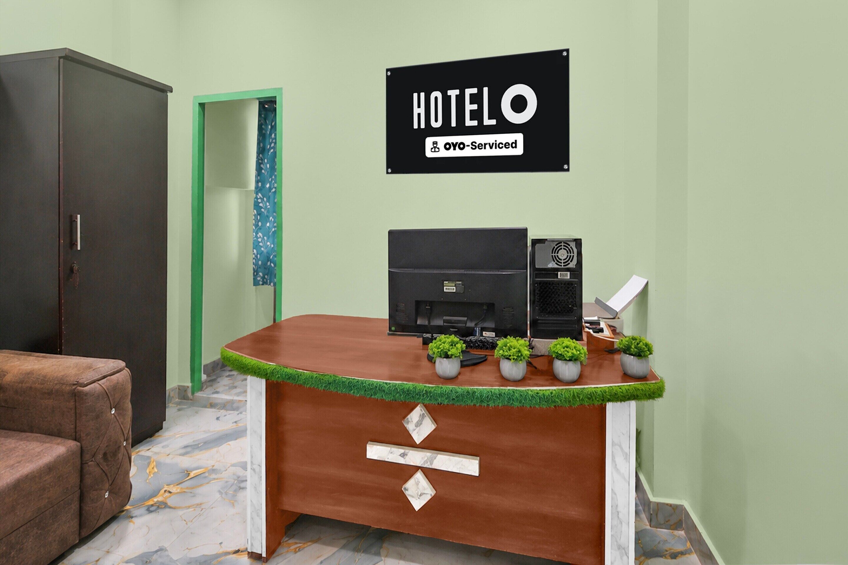 A reception desk with a sign indicating it's serviced by OYO.