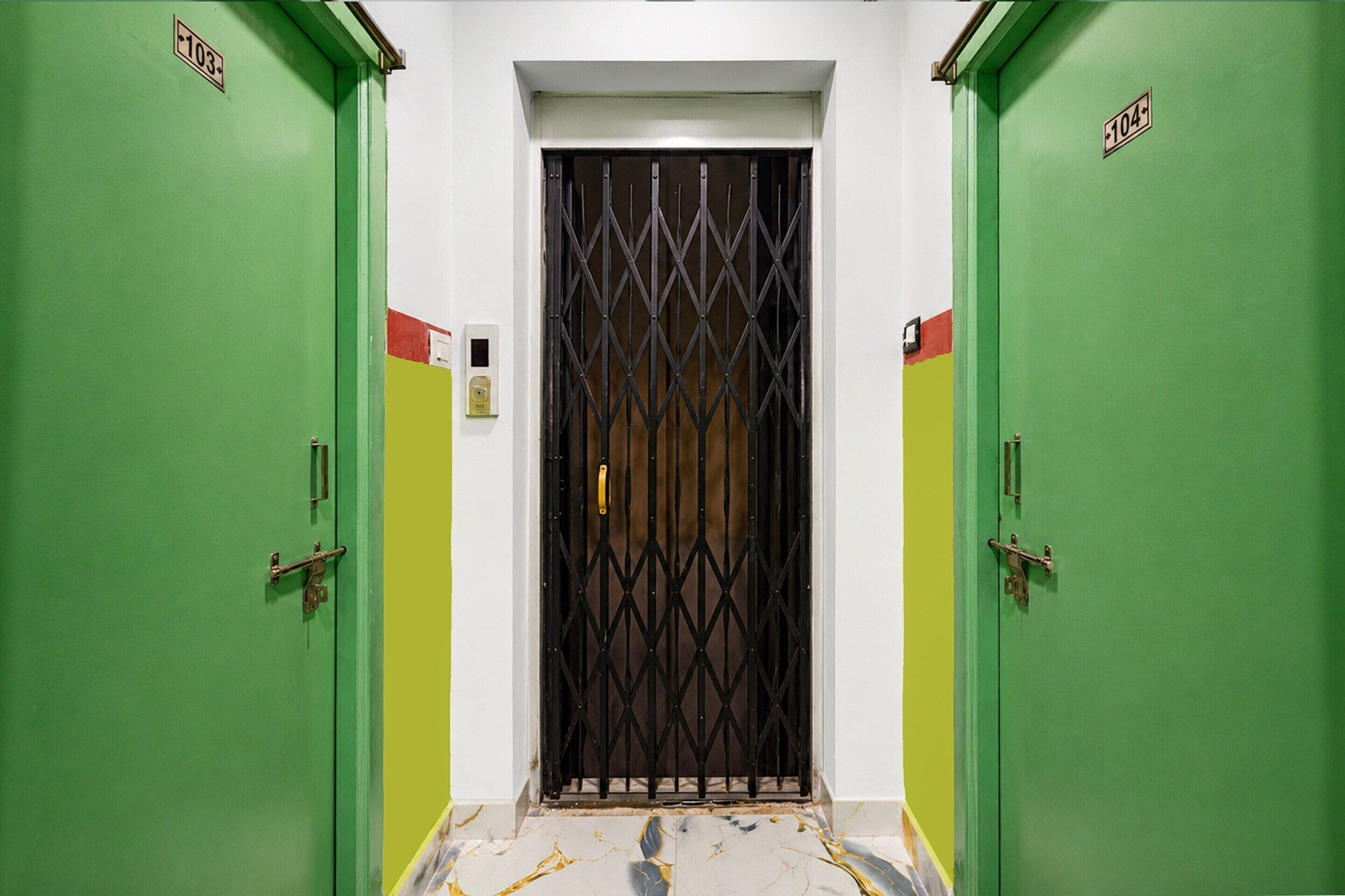 A hallway with two green doors, each marked with a number.