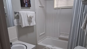 A bathroom with a sink, toilet, and bathtub.