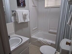 A bathroom with a sink, toilet, and bathtub. - Kimberling Cove Resort (Kimberling City)