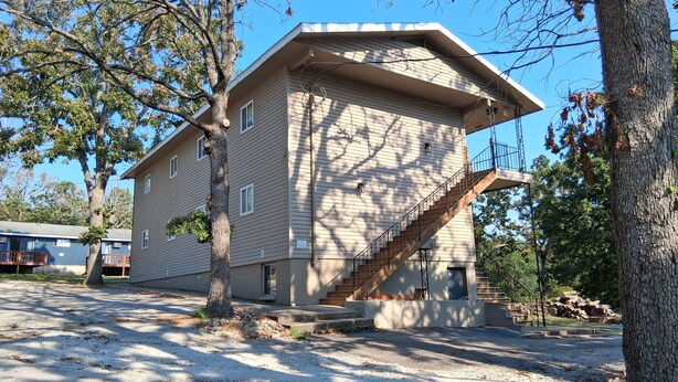 A multi-story building with a staircase leading to the entrance.