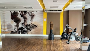 A gym with exercise equipment, a wooden floor, and a wall with a mural. - 2802 Parc Apto 3 qtos Luxo com Garagem (Belém)