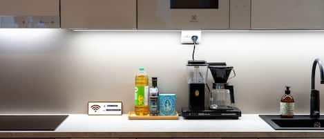 A kitchen with a coffee maker, a microwave, and a Wi-Fi symbol on the wall.