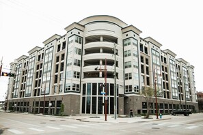 A multi-story residential building with a curved facade, large windows, and a central entrance. - Downtown Houston Skyline Stay, Steps to Daikin Park H (Houston)